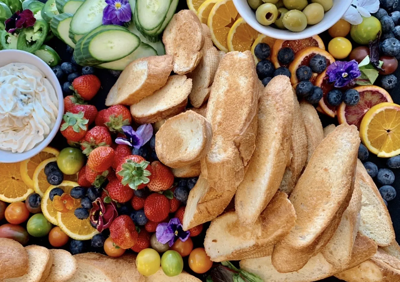 Catering platter with crostini, fresh fruit, vegetables and dips at GreenHouse