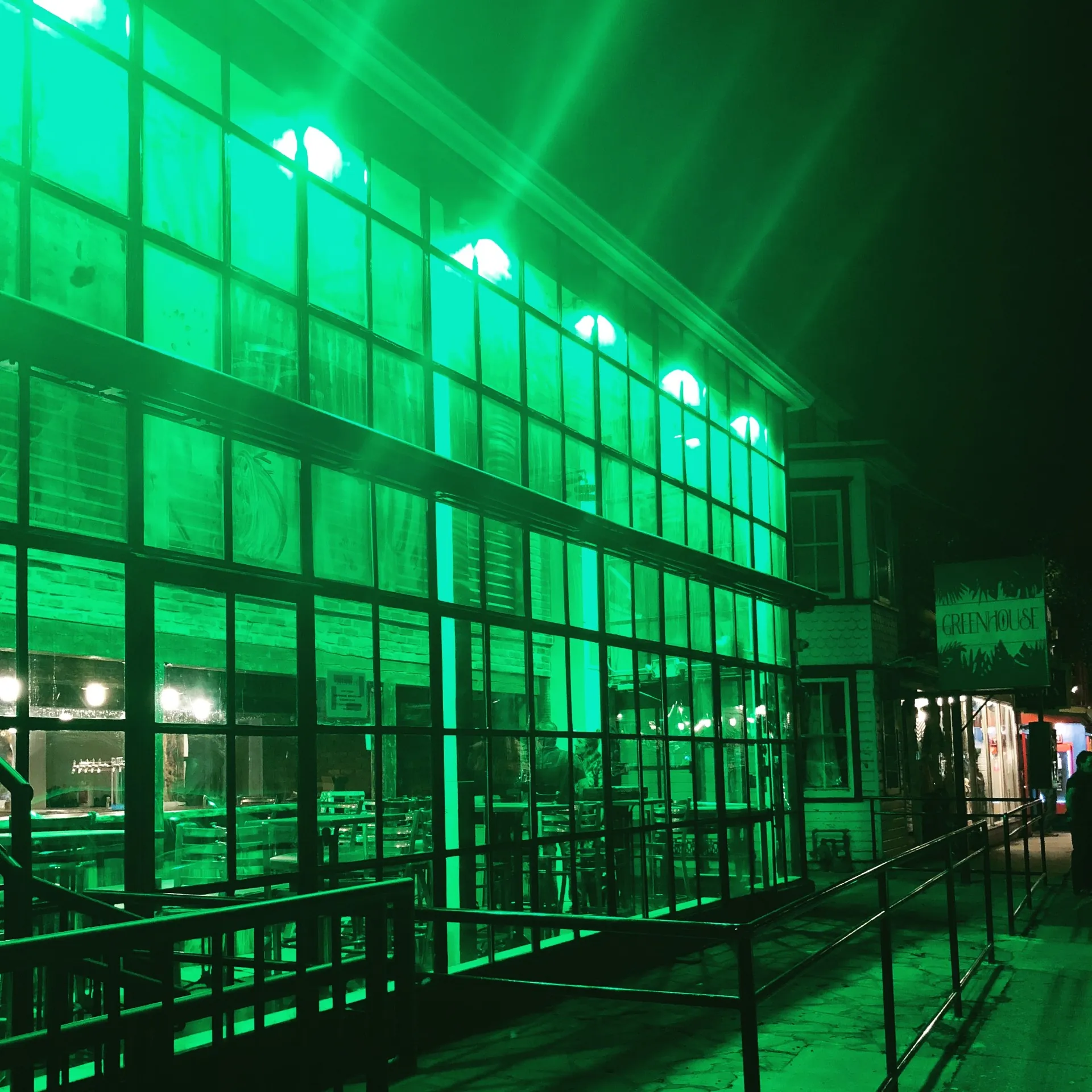 GreenHouse glass storefront lit up at night on Main Street in New Hope, PA